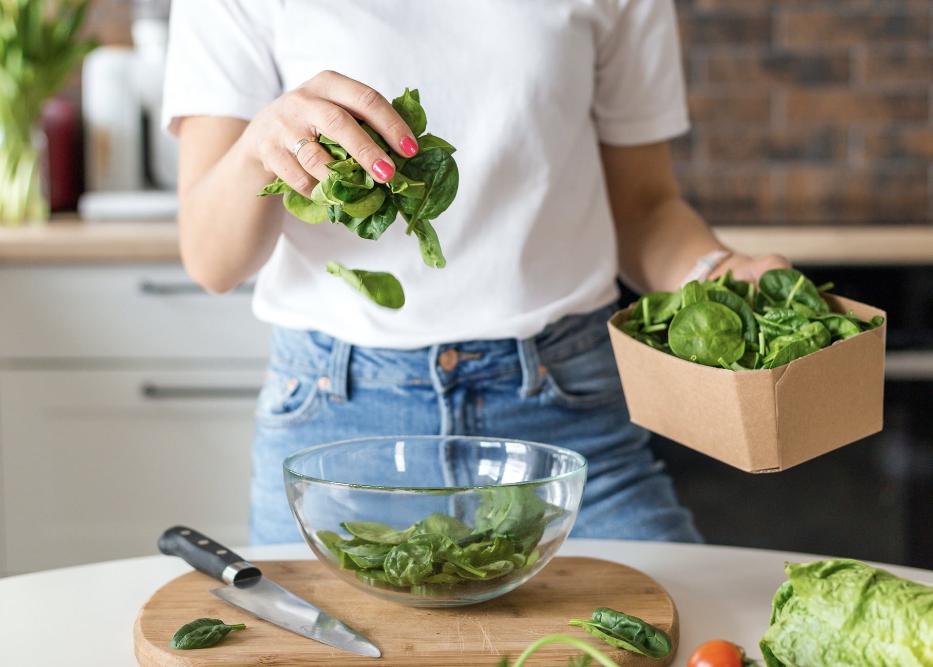 Woman preparing spinach in the kitchen